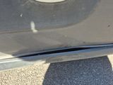 a close up of a car ' s bumper with a hole in it