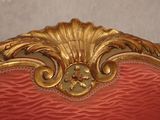 a red and gold bed with a gold frame