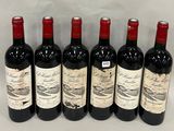 six bottles of red wine lined up in a row on a table