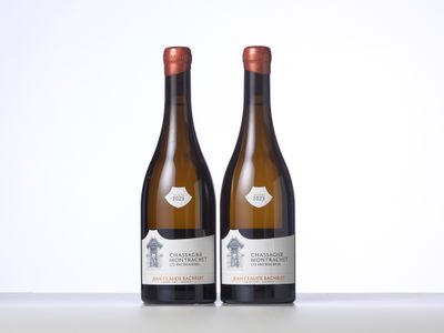 two bottles of wine sitting on top of a table