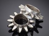 a close up of two silver rings on a black surface