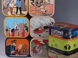 several tinned tinned tinned containers with cartoon characters on them