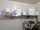 a kitchen with a lot of pots and pans on the shelves