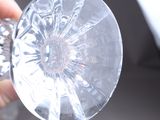 a person holding a clear glass with a hole in it
