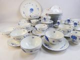 a lot of blue and white plates and bowls on the table