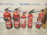 several fire extinguisors are lined up on a table