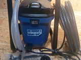 a vacuum that is sitting on the floor next to a hose