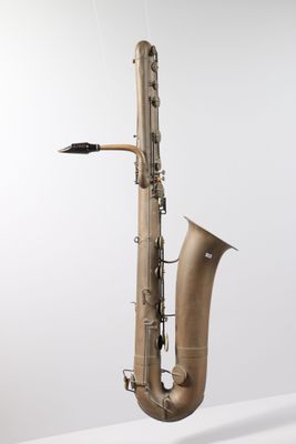 a close up of a saxophone on a white surface with a white background
