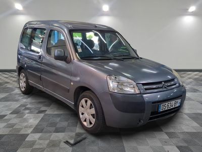 a small grey van that is parked on a checkered floor