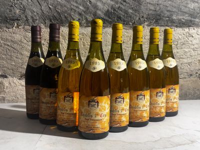 several bottles of wine are lined up on a table