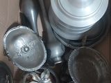 a cardboard box filled with assorted metal items