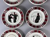 six plates with black and red designs on them on a table
