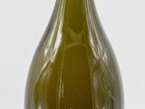 bottles of wine are lined up in a row on a white surface