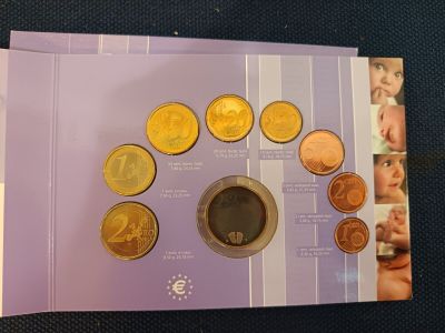 purple booklet with a picture of a cup of coffee and coins