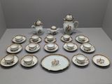 a lot of tea and coffee cups and saucers on the table