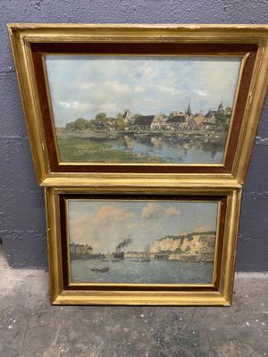 two framed paintings of a river scene with buildings and a boat