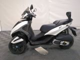 a picture of a white and black scooter parked on a checkered floor