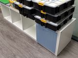 many boxes stacked on top of each other on a shelf