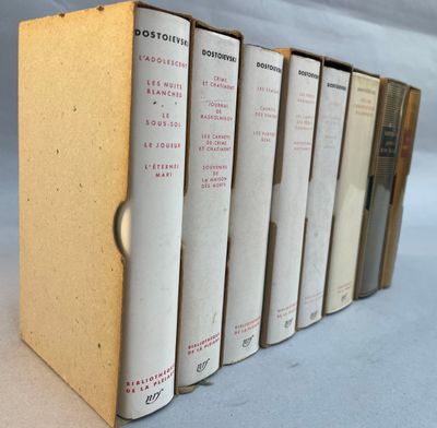 six books are lined up in a row on a white surface
