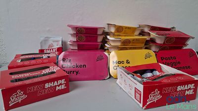 several boxes of food sitting on top of a table next to each other