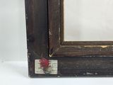 an old picture of a picture frame with a red rose on it