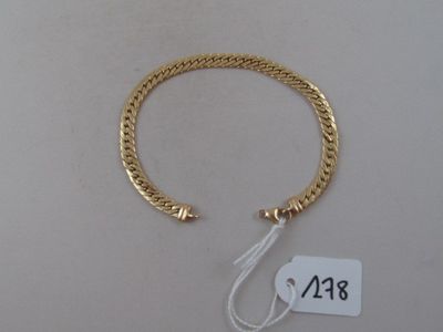 a close up of a gold bracelet with a price tag on it