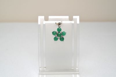 a close up of a small glass display case with a pair of earrings on it