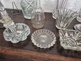 a lot of glass vases and dishes on a table