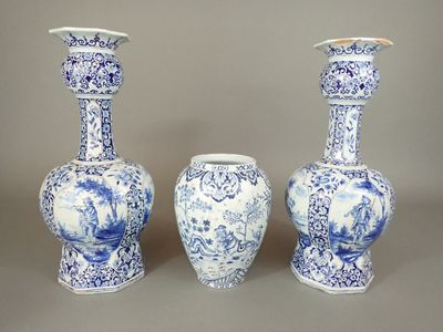 three blue and white vases sitting next to each other