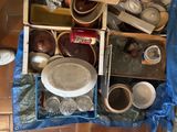 many bowls and pans that are sitting on the floor