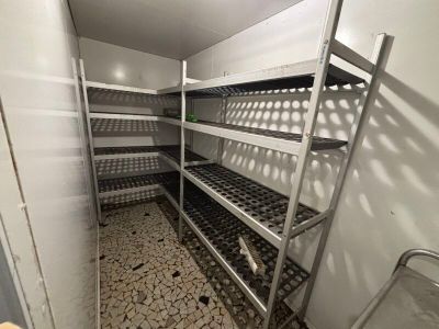 a room with shelves and a ladder in it