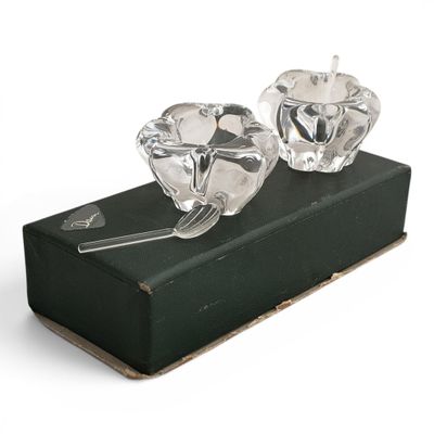 a pair of crystal candlesticks sitting on a black box