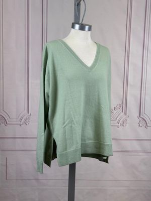 green v - neck sweater on a mannequin base