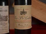 two bottles of wine sitting next to each other on a table