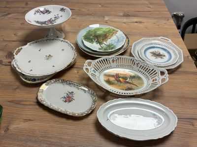 many plates and bowls sitting on a wooden table