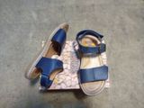 a pair of sandals that are on top of a box