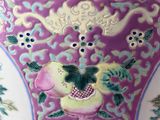 a purple vase with flowers and birds painted on it