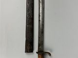 two old knives on a white surface next to each other