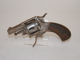 an old revolver with a wooden handle on a white surface
