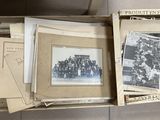 boxes of old photographs are stacked on top of each other on the floor