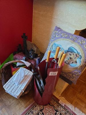 a basket full of items sitting on the floor next to a red wall