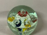 a glass object with a bunch of different colored objects inside of it