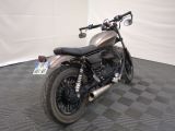 a motorcycle that is parked in a room with a checkered floor