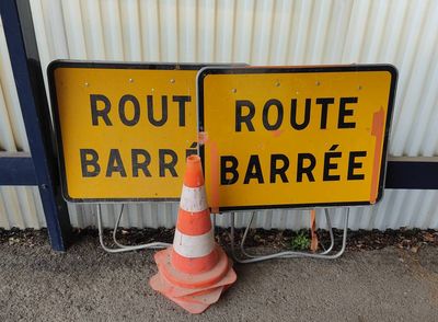 two road signs on the side of the road