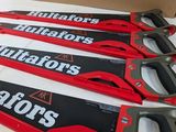 four red and black hand saws sitting on top of a table