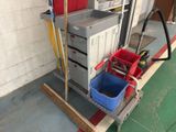two buckets and a mop on a cart in a garage