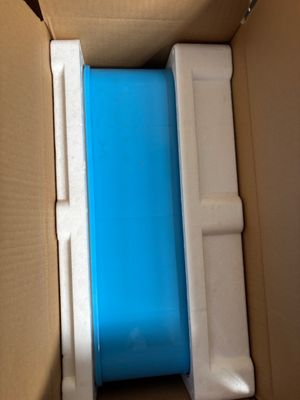 a blue and white container in a cardboard box