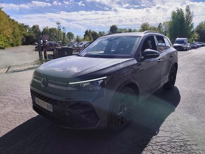 a grey suv that is parked on the side of the road