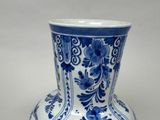 a blue and white vase sitting on a table