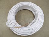 a close up of a coil of white electrical wire on a table